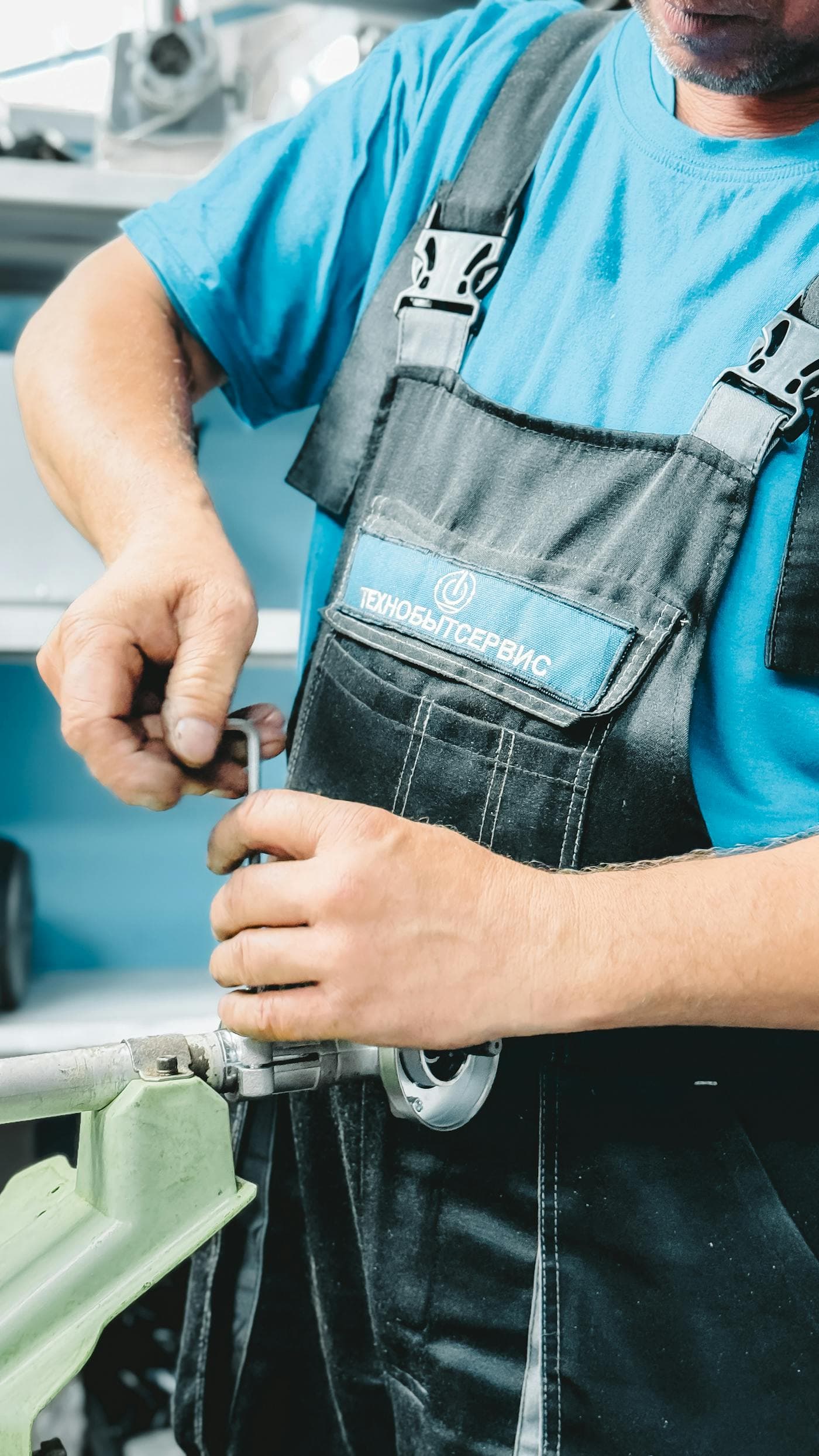 Plumber working on a residential plumbing repair with tools and hose lines